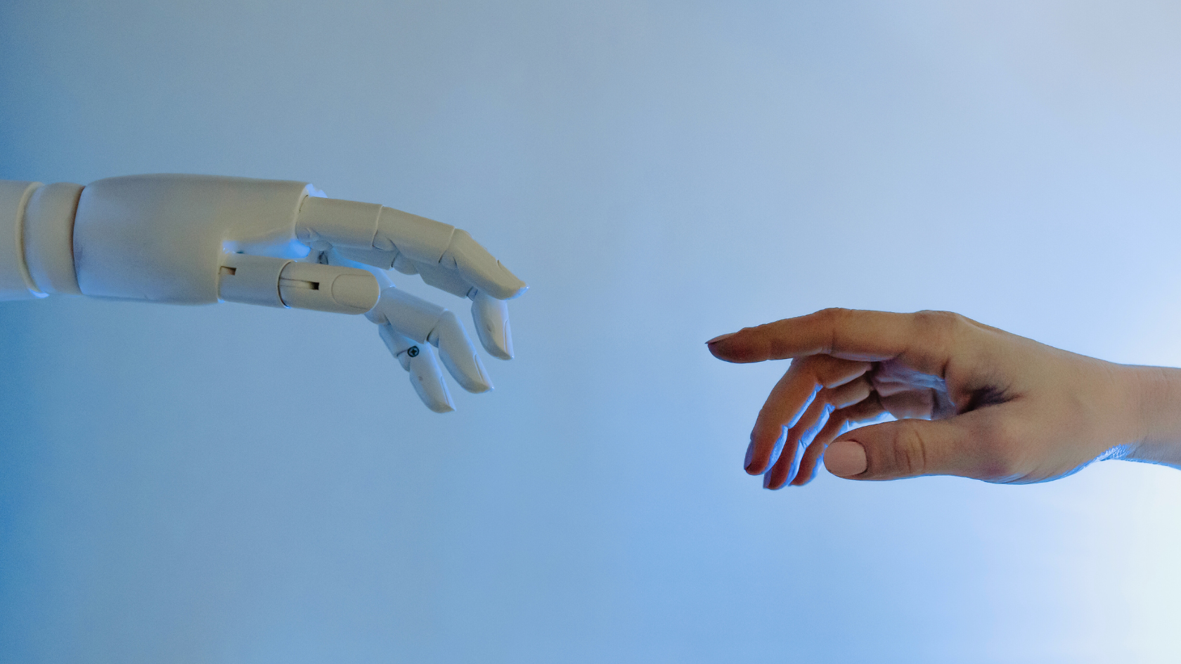 What can AI and Automation do for Staffing? Robot hand reaching for human hand